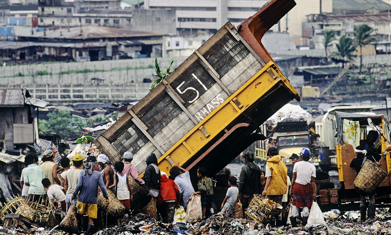On a garbage dump in India a lot of people are looking for food